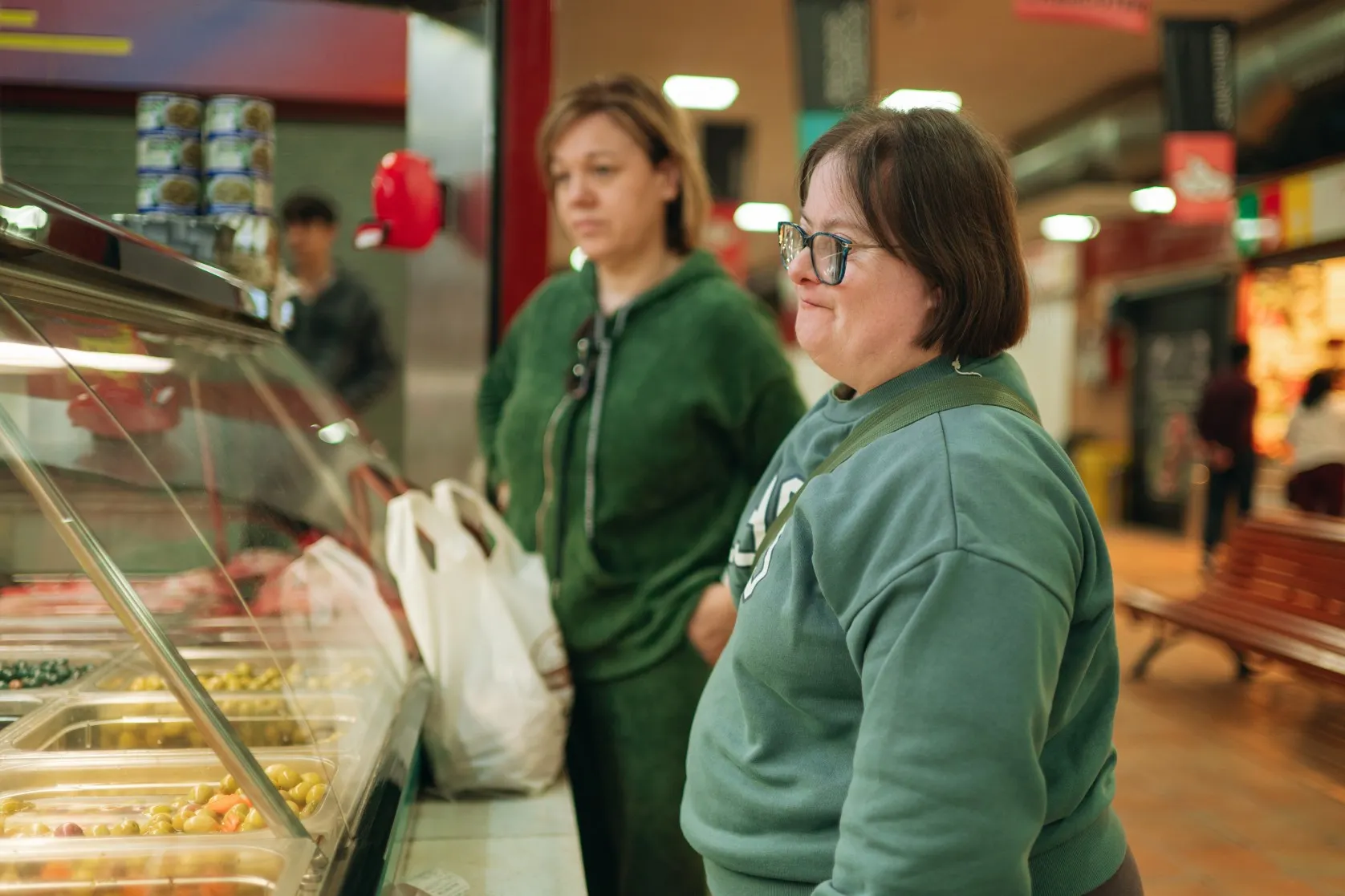 Disabled woman at supermarket with support worker